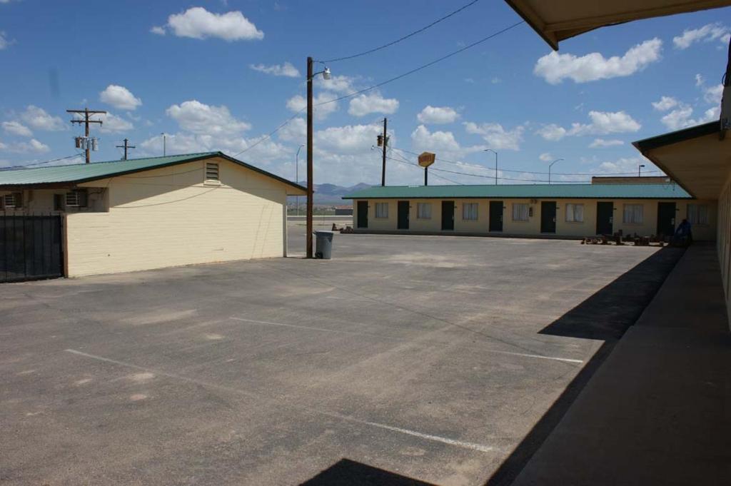 an empty parking lot in front of a building at HWY Express Inn and Suites in Thatcher