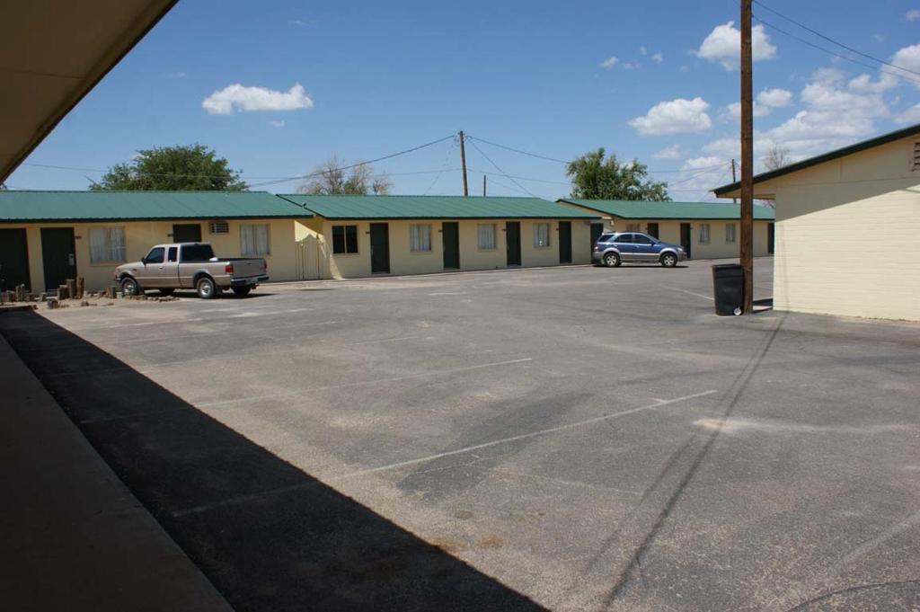 an empty parking lot in front of a motel at HWY Express Inn and Suites in Thatcher