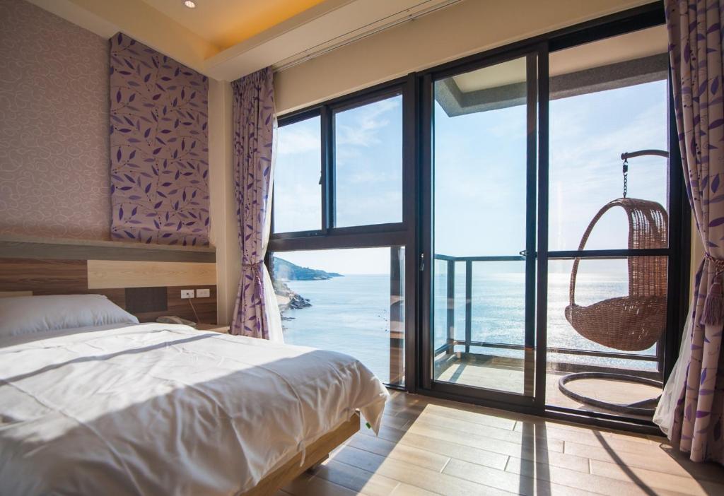 Postel nebo postele na pokoji v ubytování So Lohas B&B