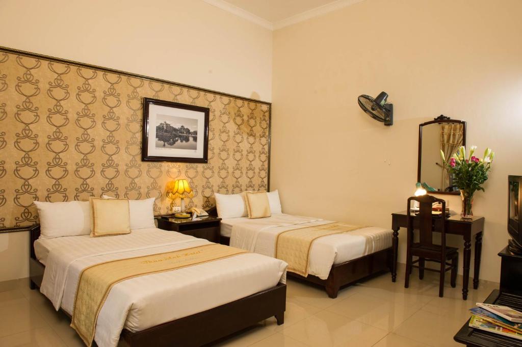 Giường trong phòng chung tại Thuy Anh Hotel