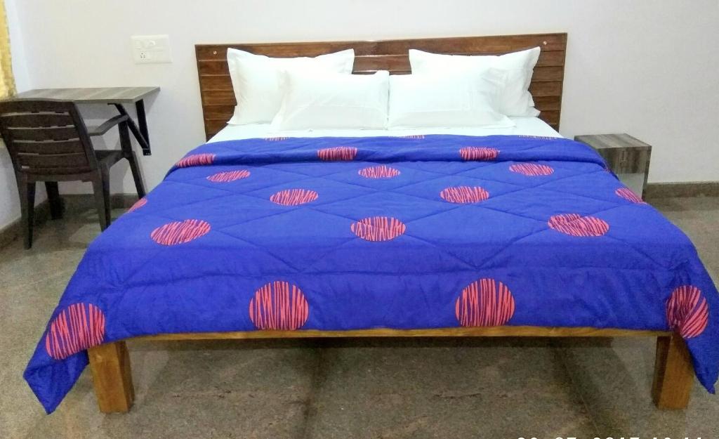 Postel nebo postele na pokoji v ubytování Aashraya Homestay