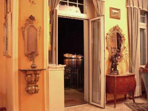 an open door to a room with a mirror at Hotel Villa Ruscello in Baveno