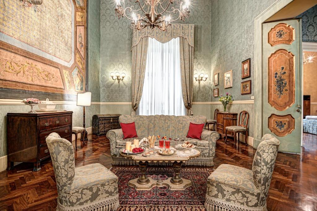 a living room with a couch and a table and chairs at Arthouse Lady Marys Tribunali Luxury Suite in Naples