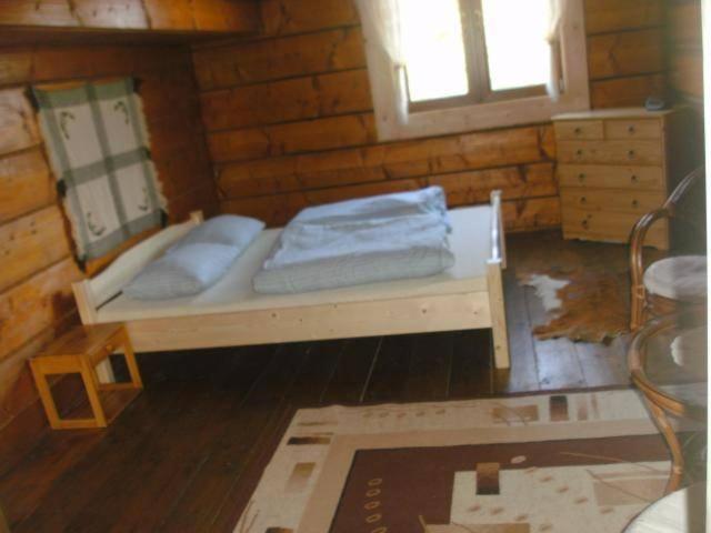 a bedroom with a bed in a wooden room at u Piwowara in Kościelisko