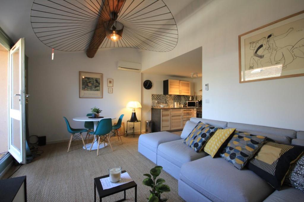 a living room with a couch and a table at Picasso - Appartement Avignon centre in Avignon