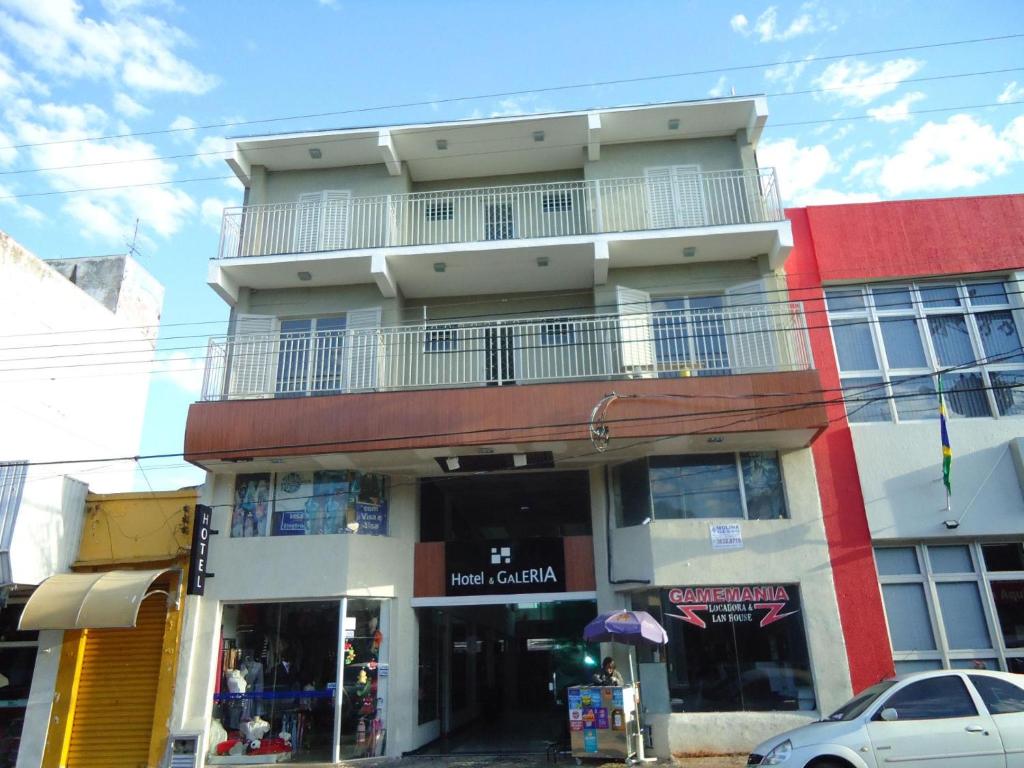 a tall building with a balcony on top of it at Hotel Galeria in Jales