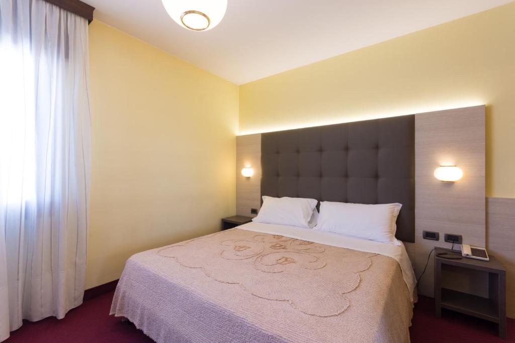 Postel nebo postele na pokoji v ubytování Park Hotel Ristorante Ca' Bianca