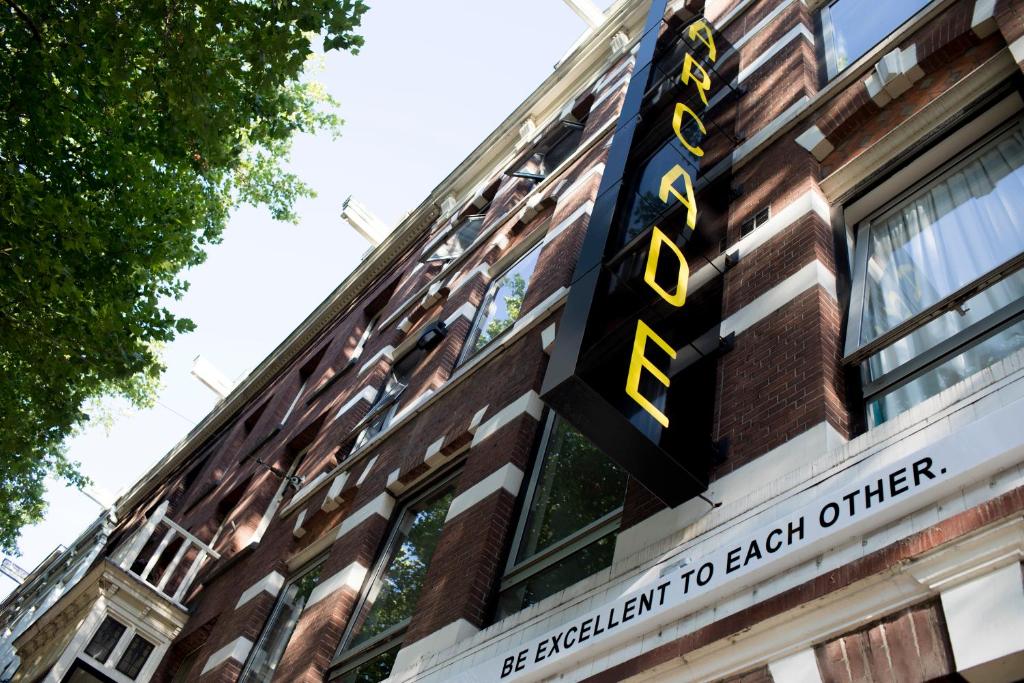 
a street sign in front of a brick building at The Arcade Hotel Amsterdam in Amsterdam
