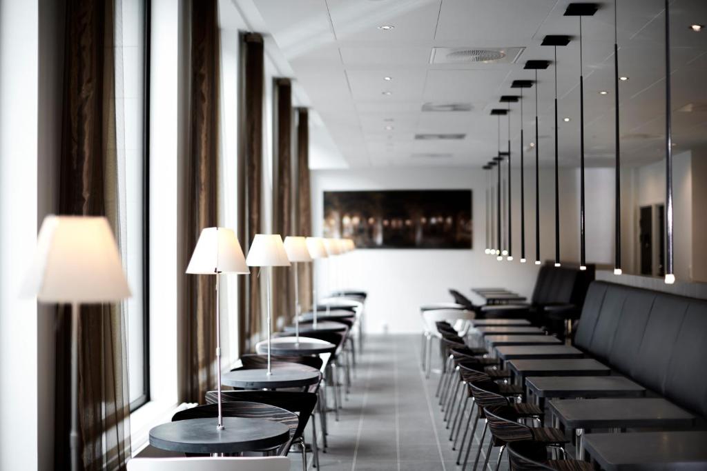 a row of tables and chairs in a restaurant at Wakeup - Aarhus in Aarhus