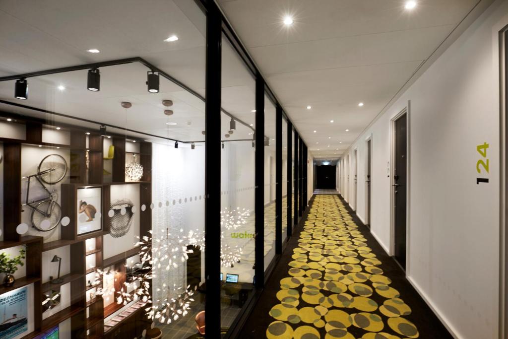 a hallway with a yellow floor in a building at Wakeup - Aarhus in Aarhus