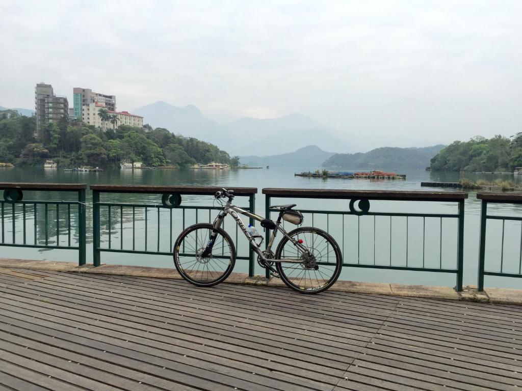 a bike parked on a bridge near a body of water at Sun Fog Hotel in Yuchi