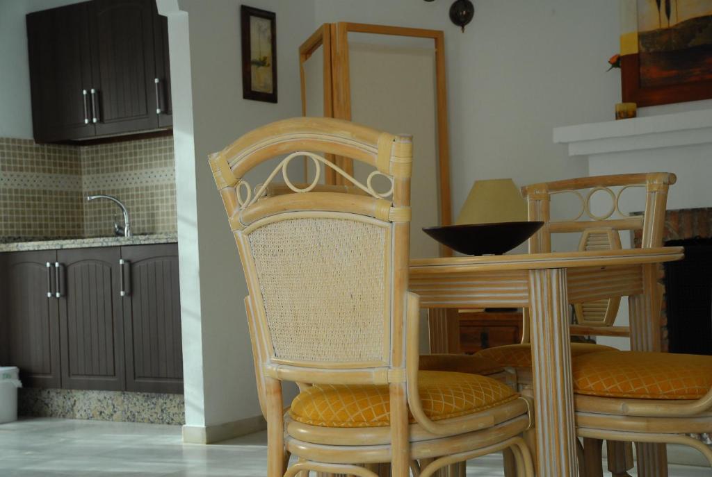 a kitchen with two wooden chairs and a table at Mijas Pueblo Apartment in Mijas