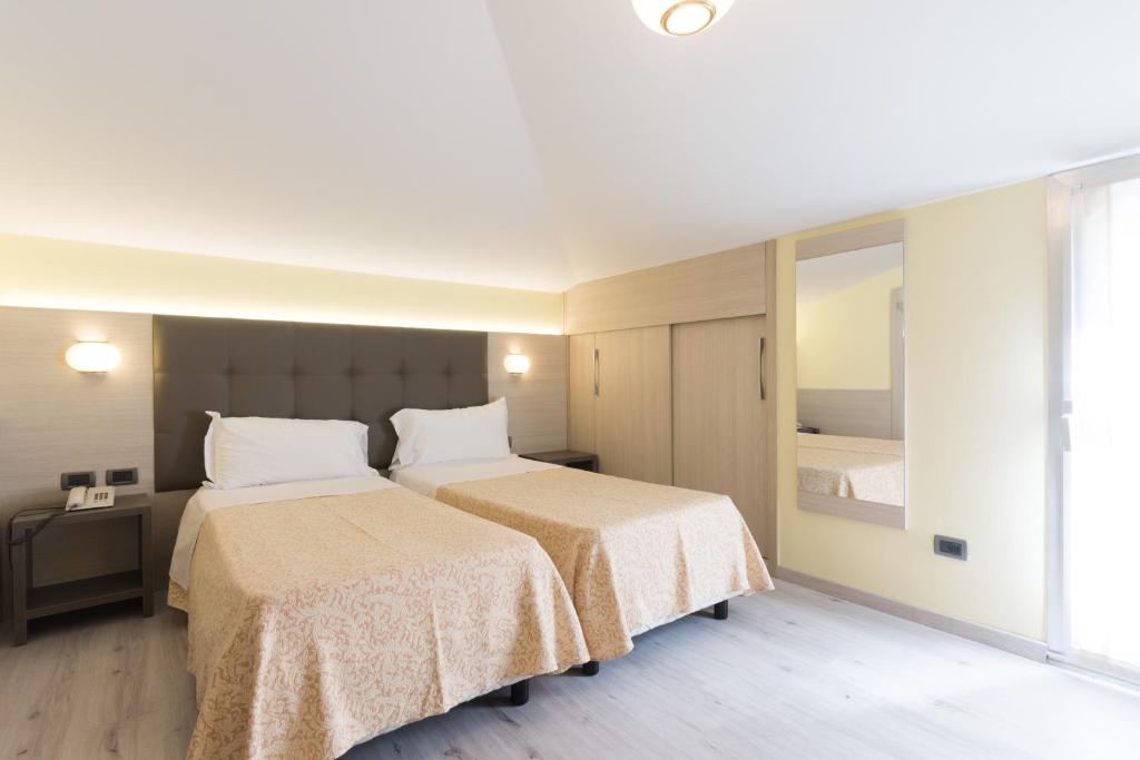 Postel nebo postele na pokoji v ubytování Park Hotel Ristorante Ca' Bianca