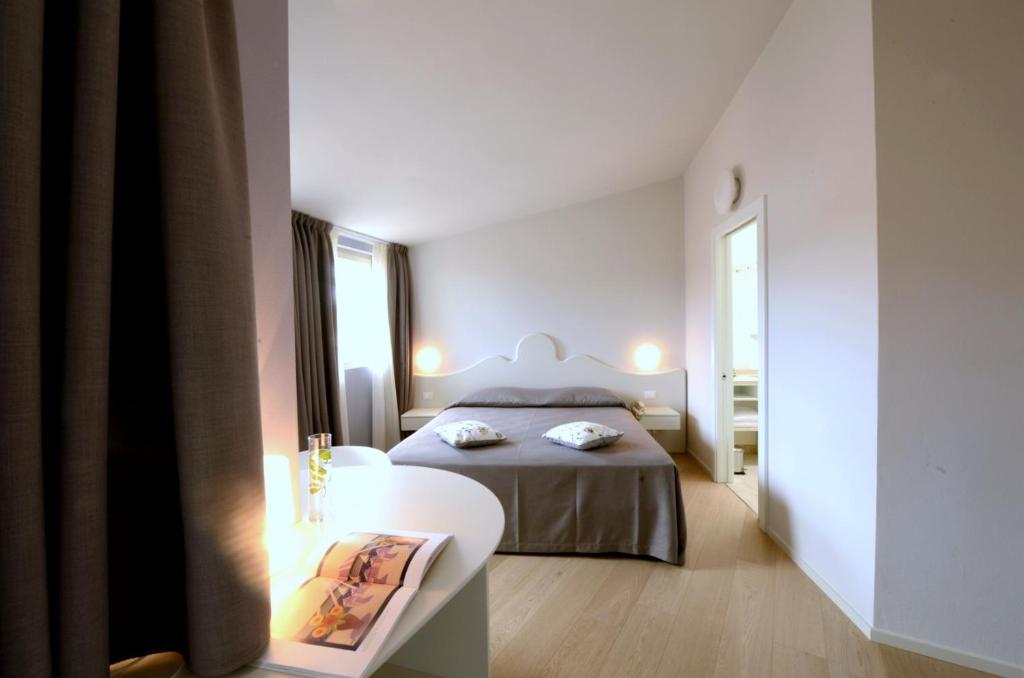 Postelja oz. postelje v sobi nastanitve Aromi Piccolo Hotel