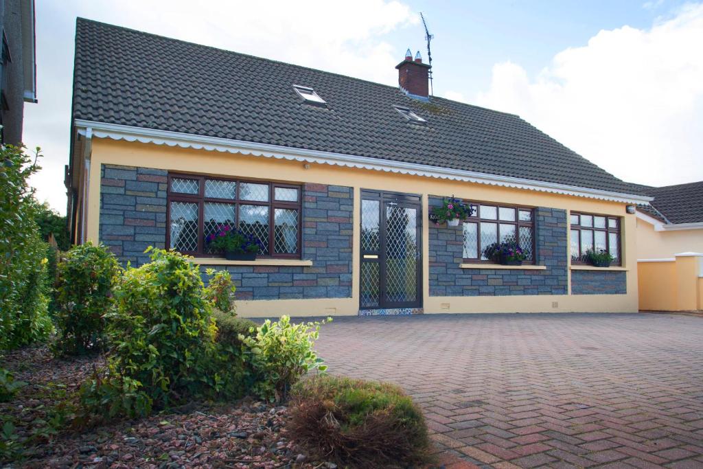 a house with a brick driveway in front of it at Krakow B&B in Dundalk