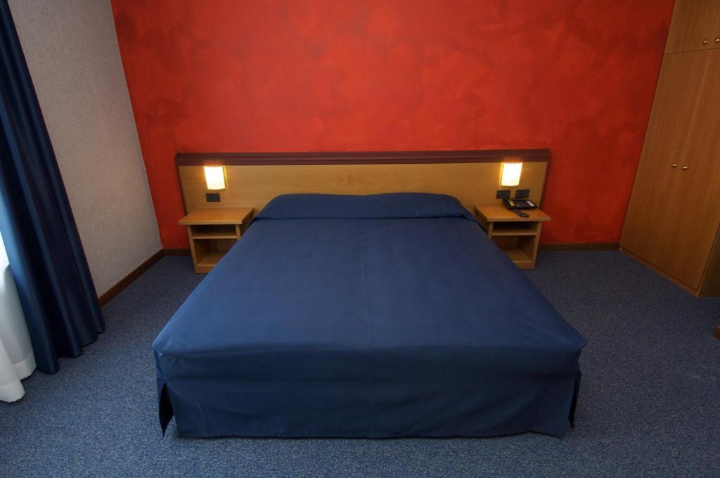 Postel nebo postele na pokoji v ubytování Hotel Residence Ducale