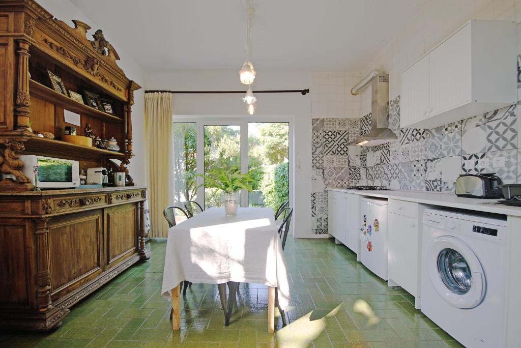 a kitchen with a table with a white table cloth at Lei Home in Cascais