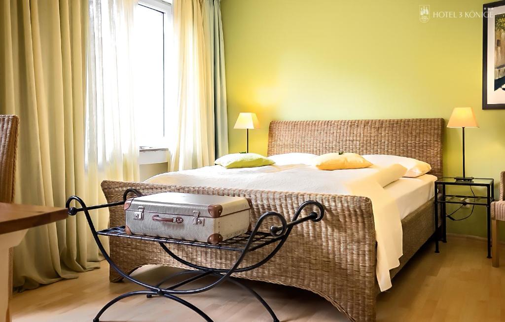 a hotel room with a bed with a suitcase on it at Hotel 3 Könige in Aachen