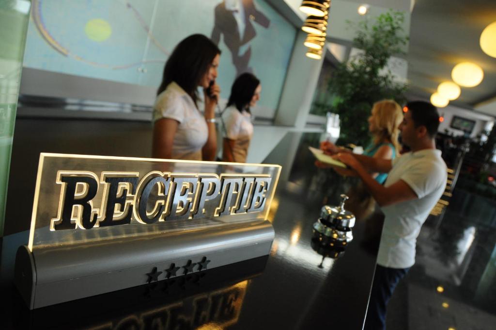 a group of people standing in a store at Hotel EMD in Bacău
