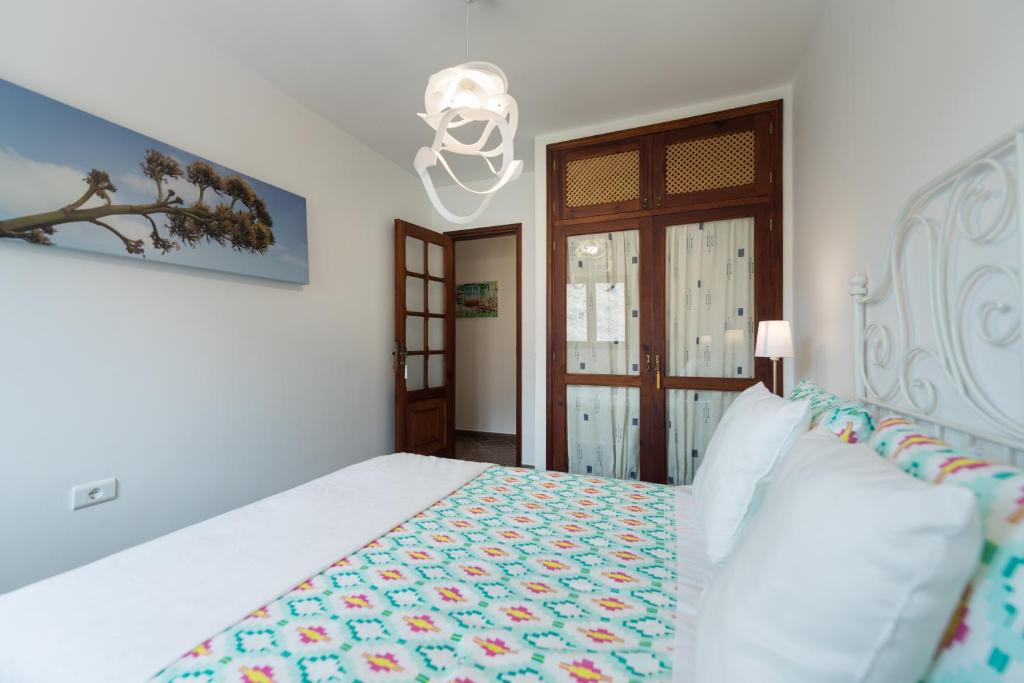 Postel nebo postele na pokoji v ubytování Casa Panchita -Maravillosas vistas al mar y montaña