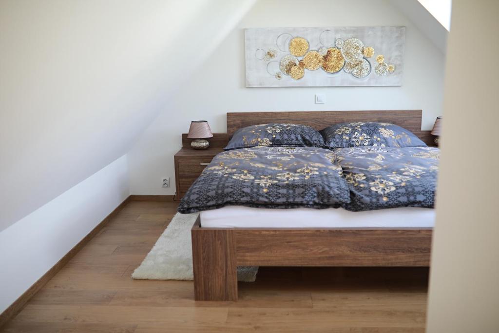 a bedroom with a bed with blue pillows at Penzion Sokolská in Zlín