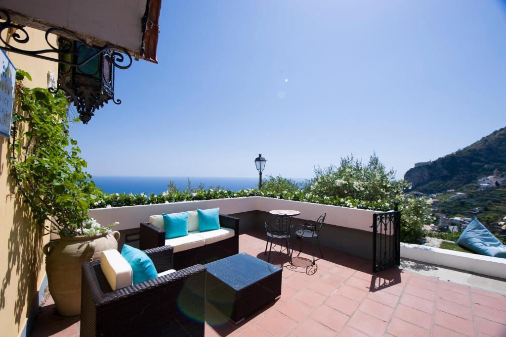 a balcony with furniture and a view of the ocean at Hotel Villa Felice Relais in Amalfi
