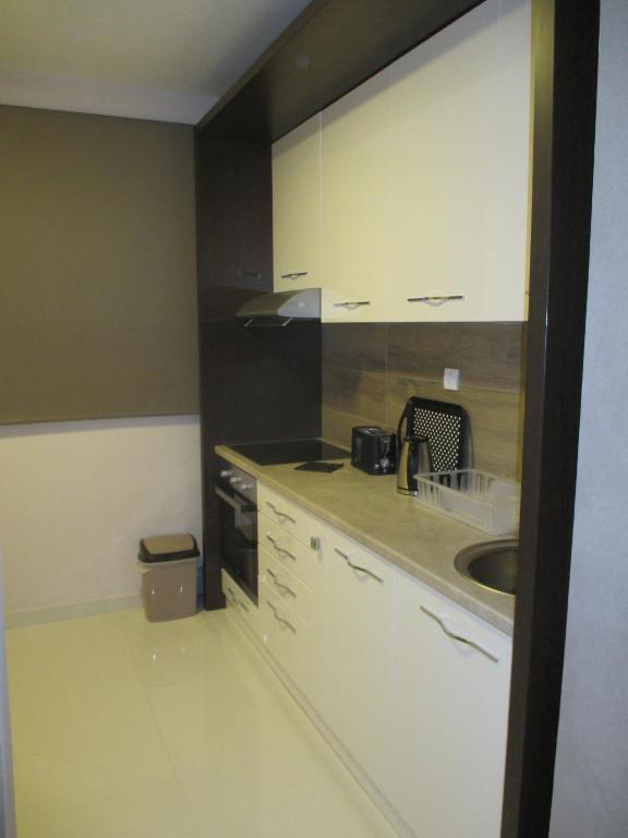 A kitchen or kitchenette at Genex Apartment