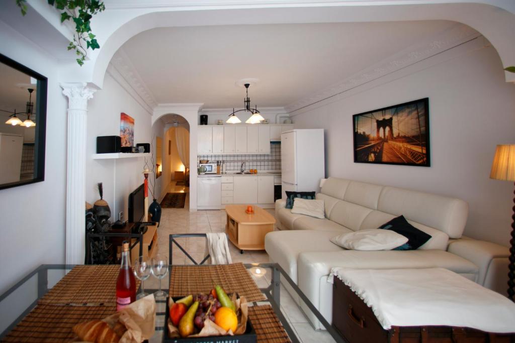 a living room with a white couch and a table at Costa del Silencio Apartment in Costa Del Silencio