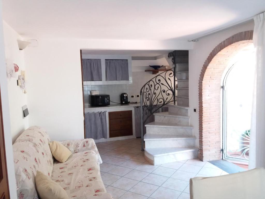 a living room with a couch and a staircase at Raffinato bilocale a Lido di Camaiore vicino al mare in Lido di Camaiore