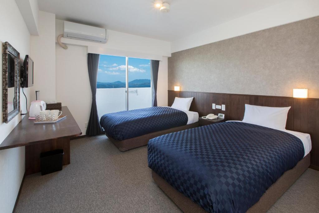Postel nebo postele na pokoji v ubytování Global Resort Miyajima View