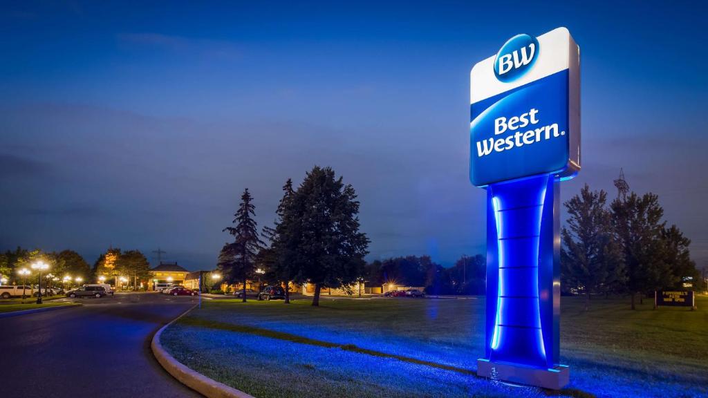 a best western sign on a street at night at Best Western Parkway Inn & Conference Centre in Cornwall
