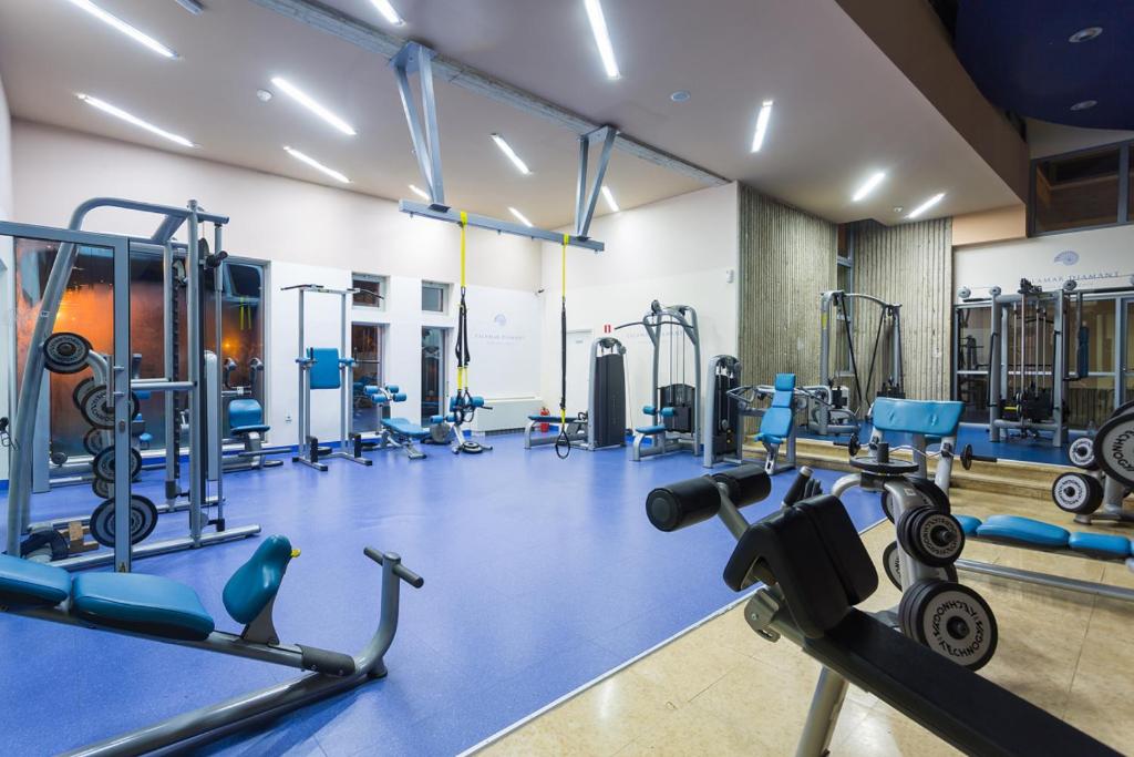 a gym with several treadmills and machines at Valamar Diamant Hotel in Poreč