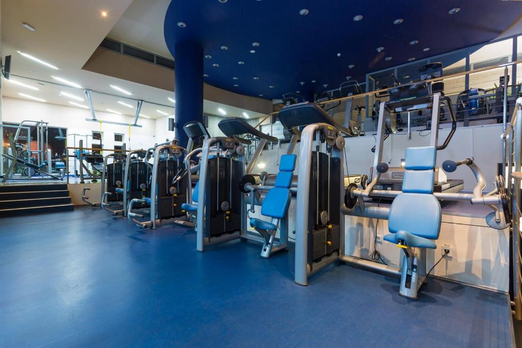 a gym with treadmills and cardio machines at Valamar Diamant Hotel in Poreč