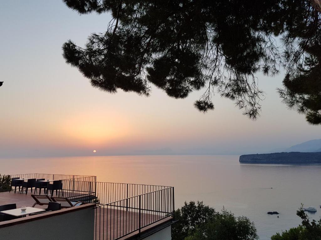 a view of the ocean at sunset from a house at Villa Crawford in San Nicola Arcella