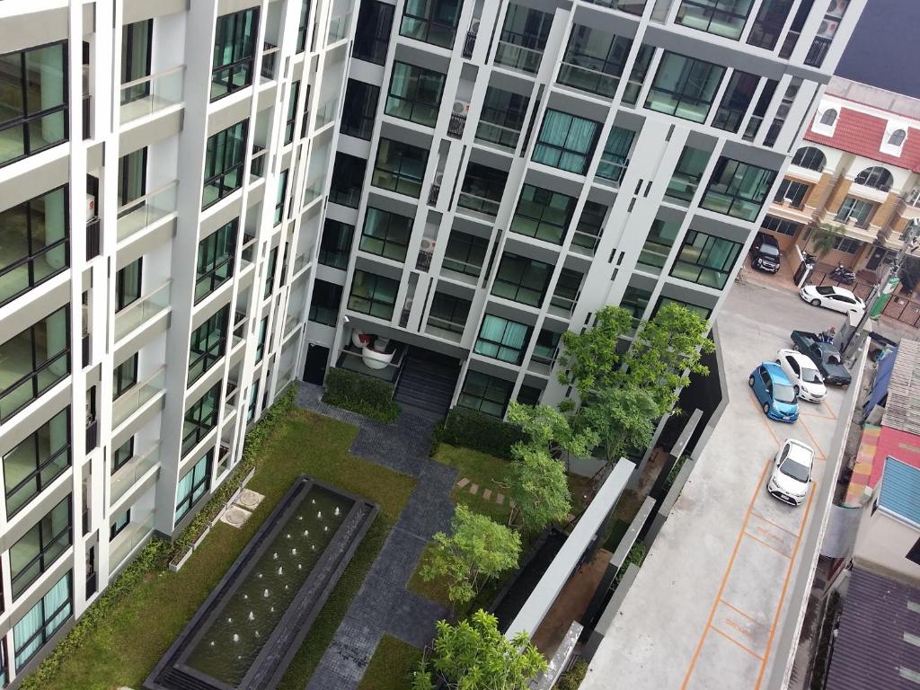 an apartment building with a garden in front of it at The Chezz by Patsamon in Pattaya Central