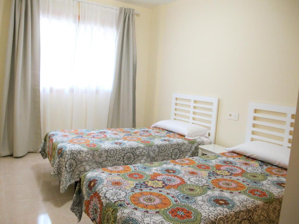 Posteľ alebo postele v izbe v ubytovaní Apartmento La Perla el Medano