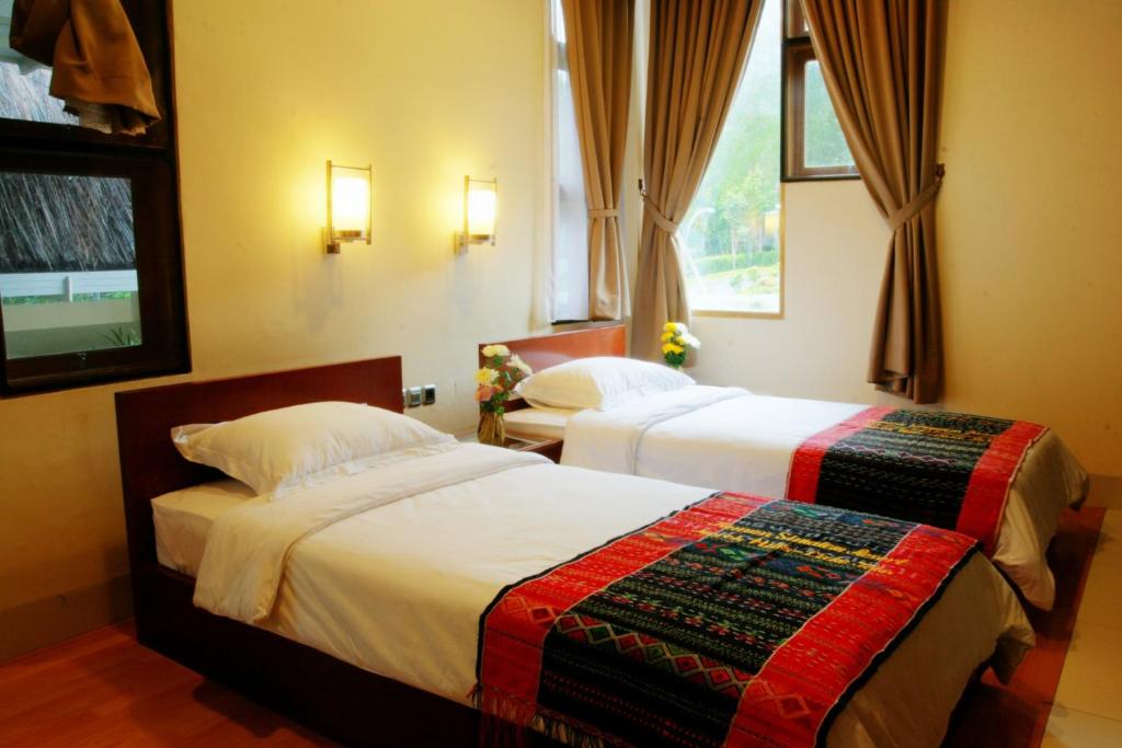 Postel nebo postele na pokoji v ubytování Taman Simalem Resort