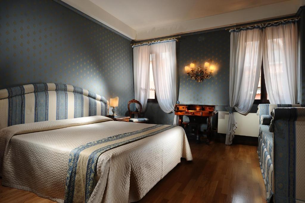 Postel nebo postele na pokoji v ubytování Hotel Abbazia