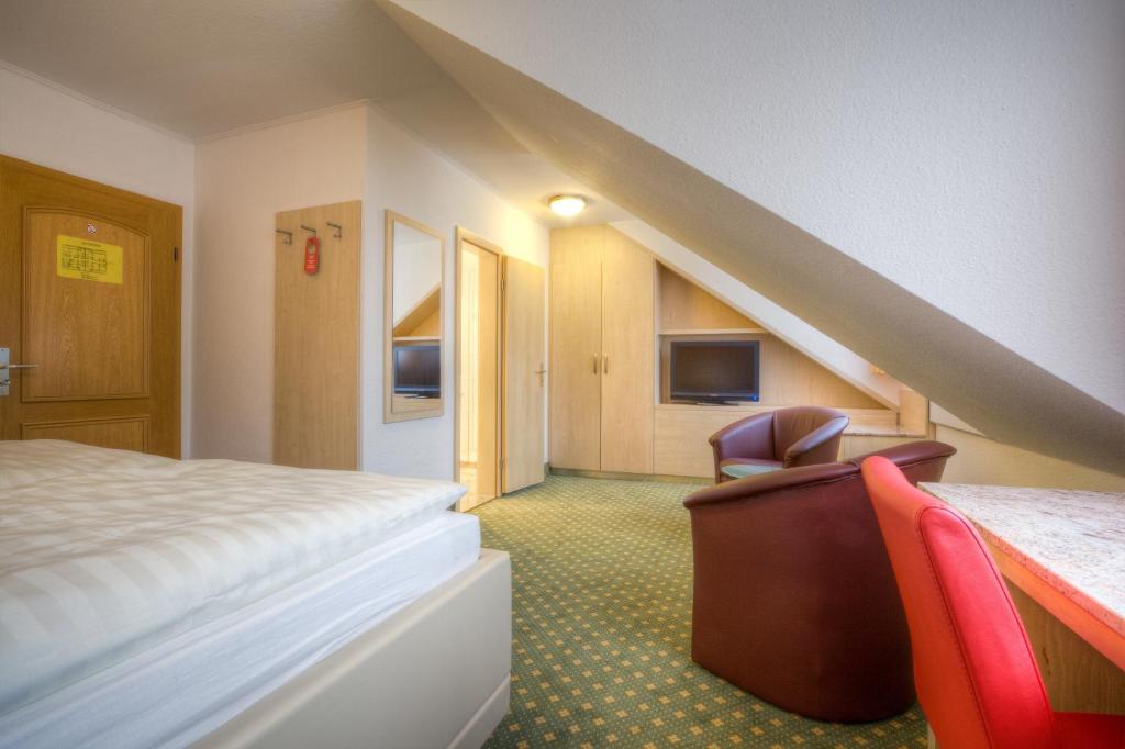 Postel nebo postele na pokoji v ubytování Hotel Stolberg