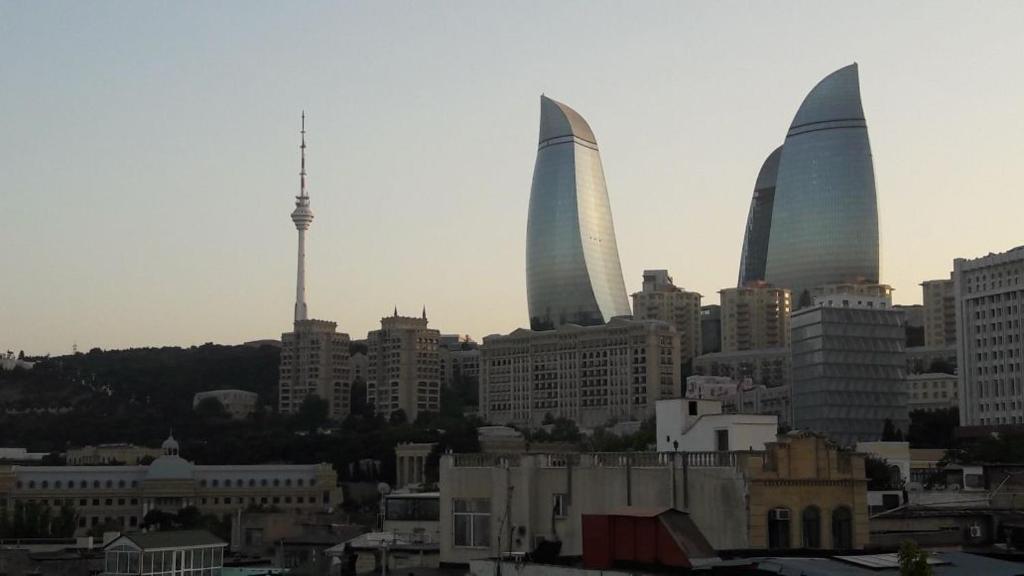 a skyline of a city with three tall buildings at Guesthouse Khazar in old city in Baku