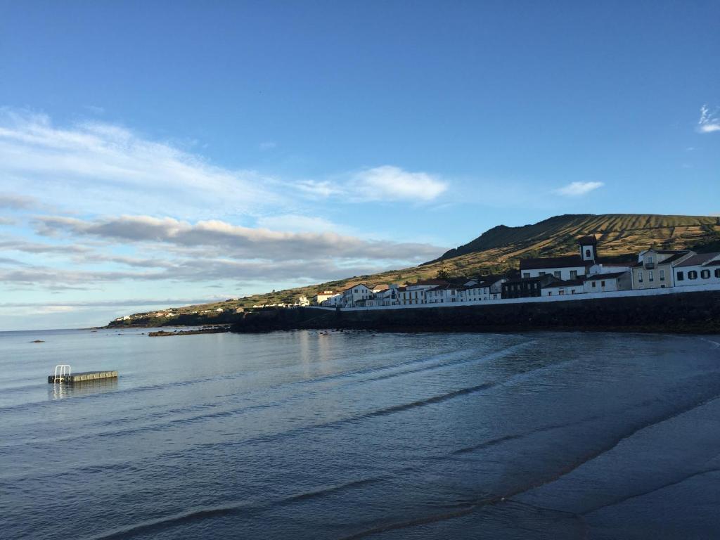 a group of buildings on the shore of a body of water at Casa da Madrinha Graciosa in Trás dos Pomares