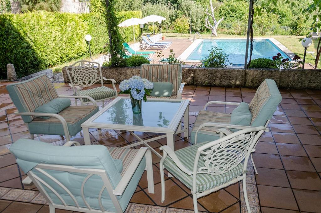a patio with a table and chairs and a pool at Casa Anceu ArchsenseApartments. in Anceu