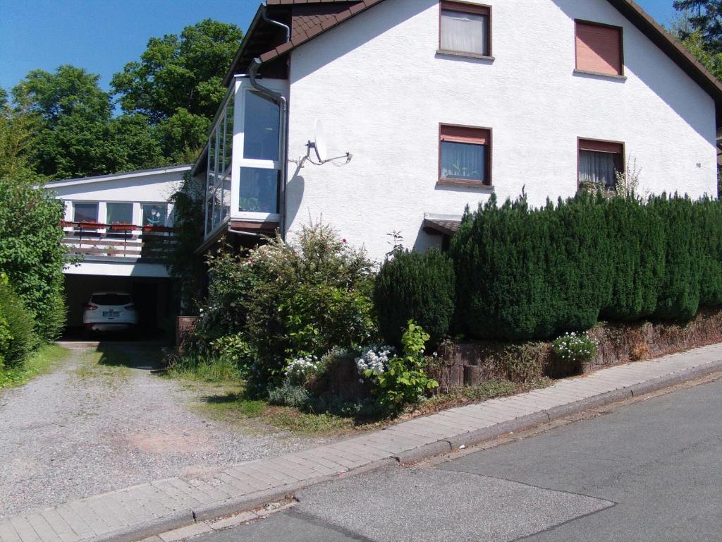 a white house on the side of a street at Ferienwohnung Mörlenbach in Mörlenbach