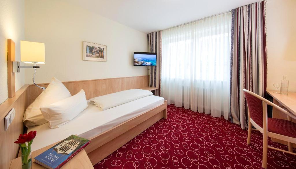 Postel nebo postele na pokoji v ubytování Hotel Löwengarten