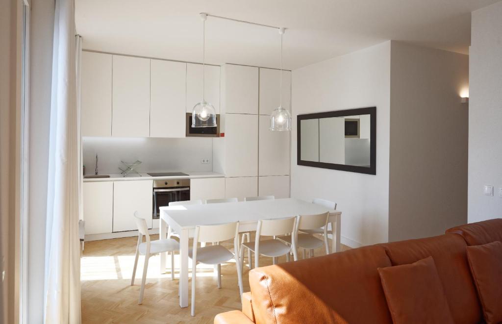 リスボンにあるCity Stays Sé Apartmentsのキッチン、ダイニングルーム(白いテーブル、椅子付)