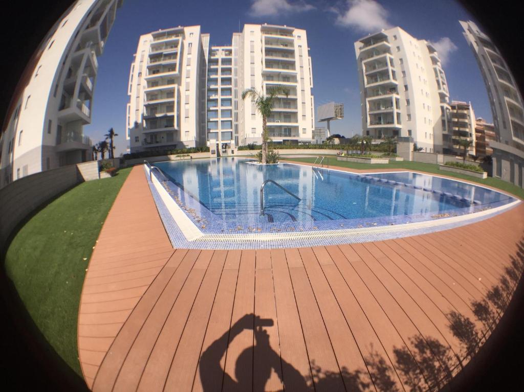 a shadow of a man standing in front of a swimming pool at Aqua Nature 27D in La Mata