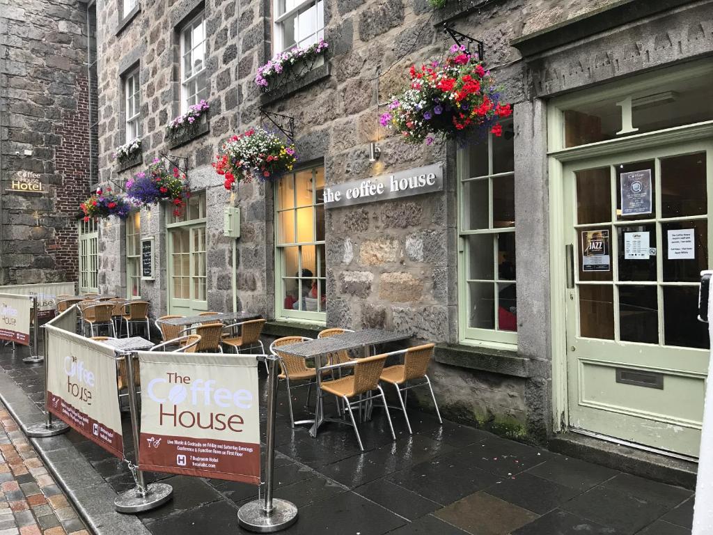 a table and chairs outside of a coffee house at The Coffee House Hotel in Aberdeen