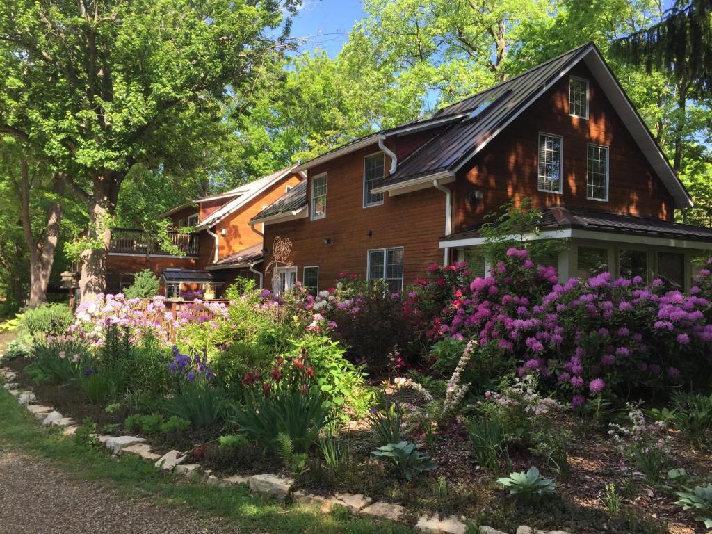 a garden in front of a house with flowers at Goldberry Woods- A Modern Farm Resort in Union Pier