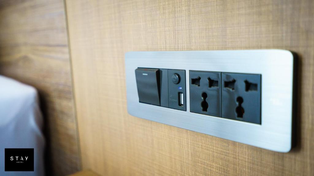 A bedside control panel with universal outlets and USB charging.