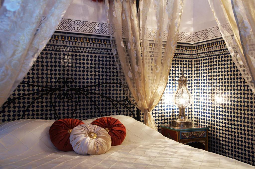 a bedroom with a bed with pumpkins on it at Riad Fes Kettani in Fez